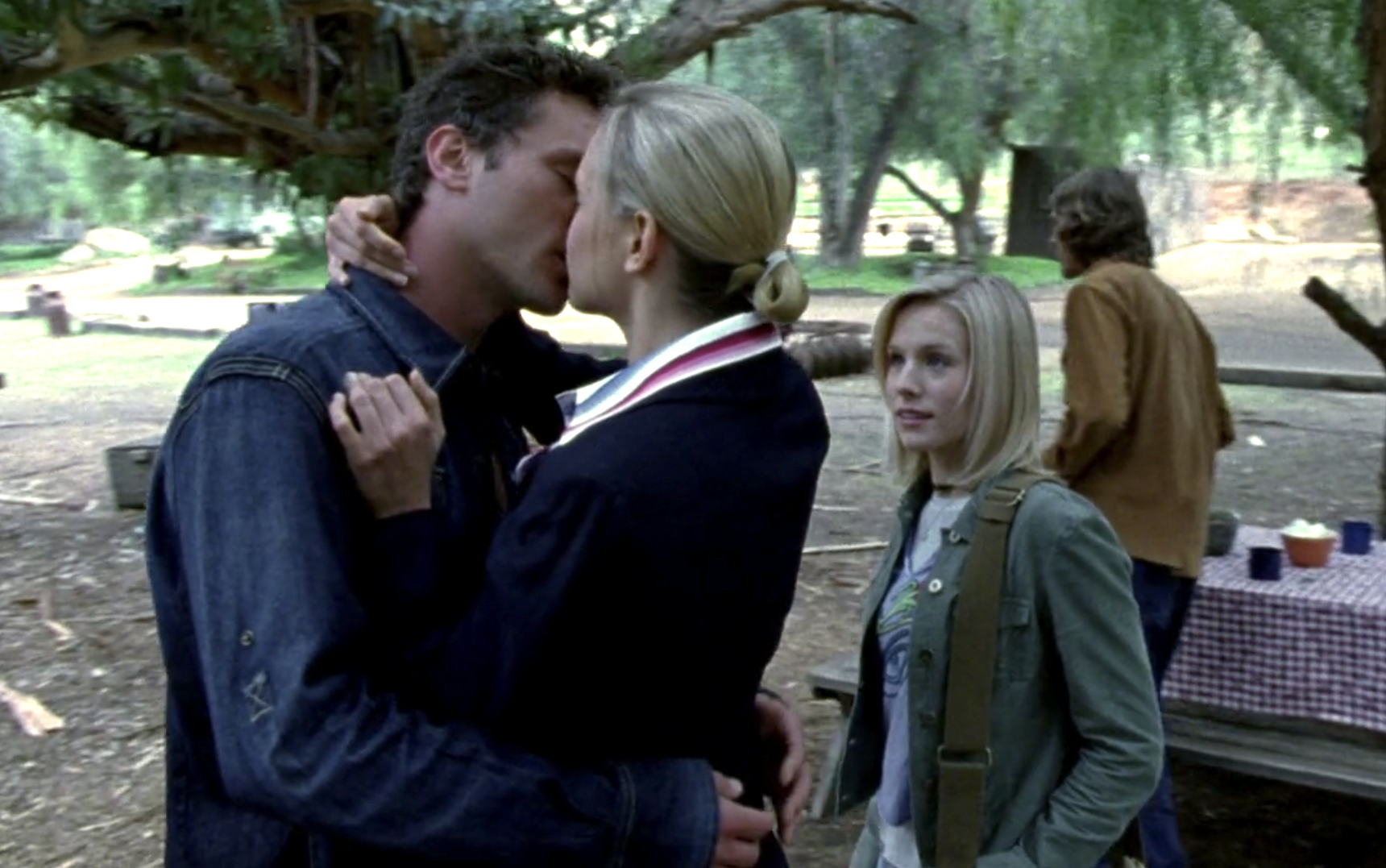Screenshot from S1E9 of Veronica Mars. Josh and Holly make out at the farm while Veronica looks on in surprise.