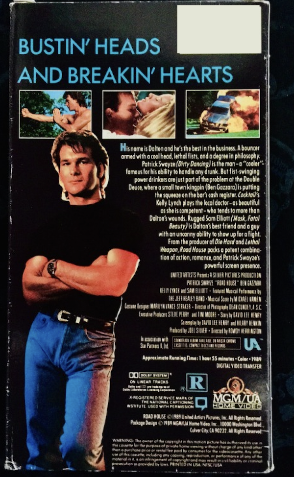 A screenshot of the back of a VHS case for the movie Roadhouse. It hs a photo of Patrick Swayze and at the top it reads in blue capital letters "Bustin' heads and breakin' hearts."