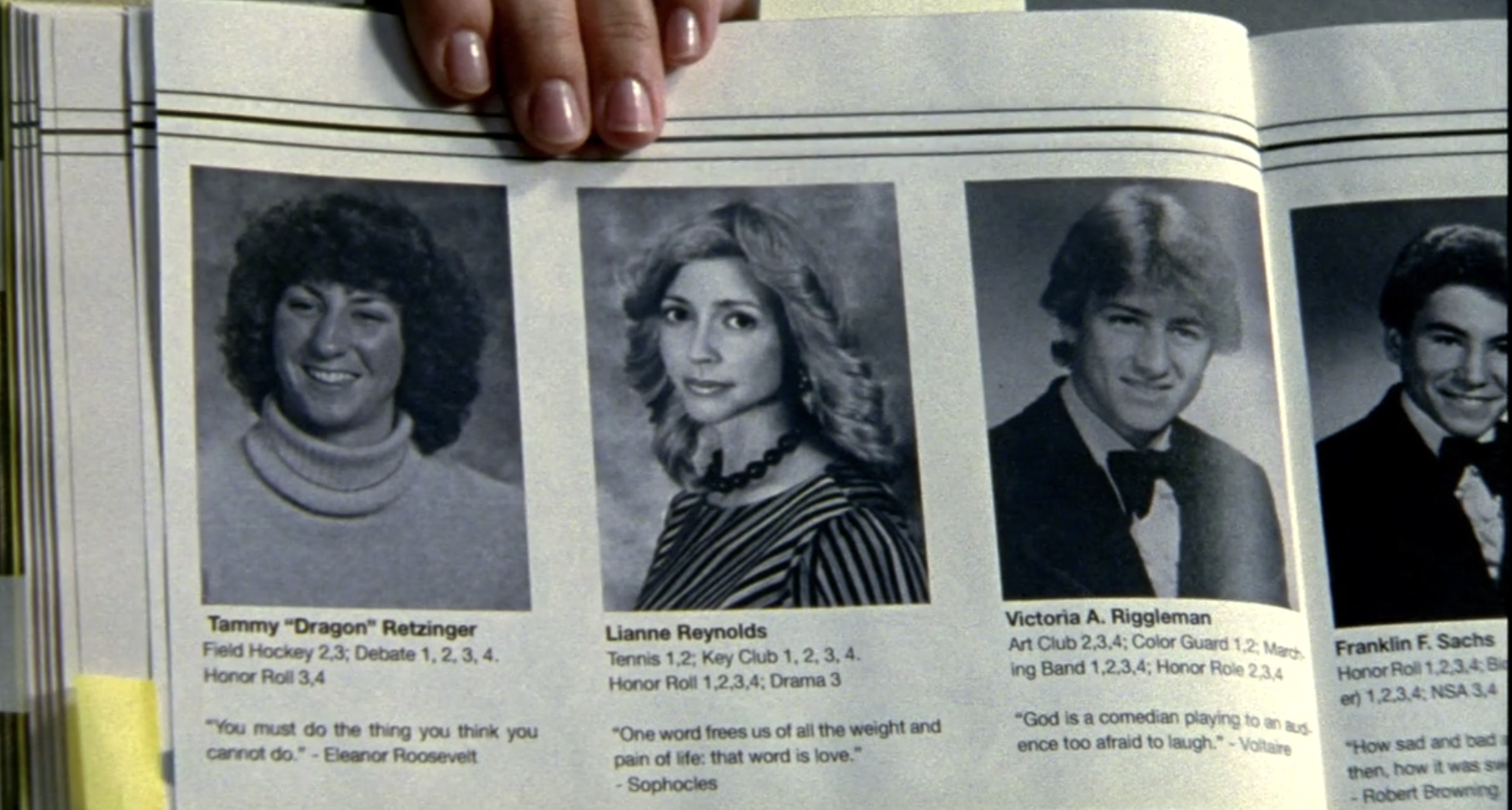 A screenshot from S1E7 of Veronica Mars. It is a photograph of a yearbook. The photo is B&W and shows photos of four seniors, Tammy "Dragon" Retzinger, Lianne Reynolds, Victoria A. Riggelman, and Franklin F. Sachs. Each photo has the subject's extra curriculars listed along with a quote.