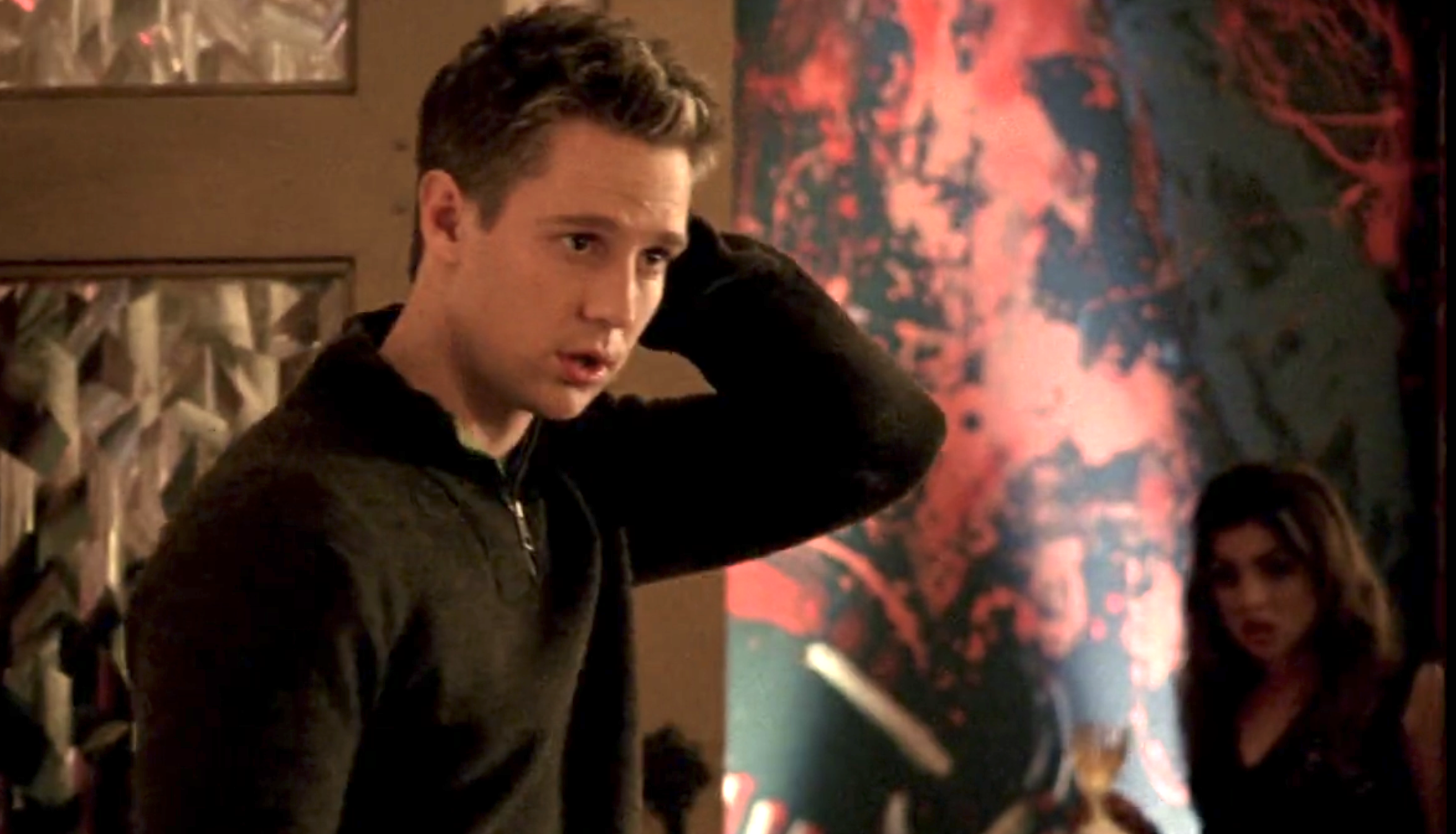 Screenshot from Veronica Mars season one, episode 10. Logan is looking with concern off-screen. His left hand is on the back of his head.