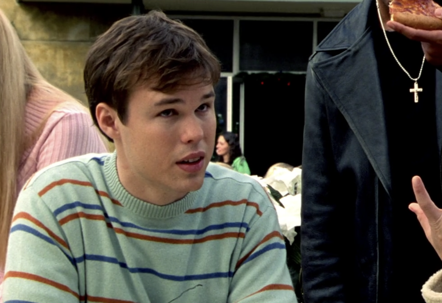 Screenshot from Veronica Mars season one, episode 10. Sean, a white teen with brown hair, in a light blue sweater with horizontal stripes looks up at someone off screen.