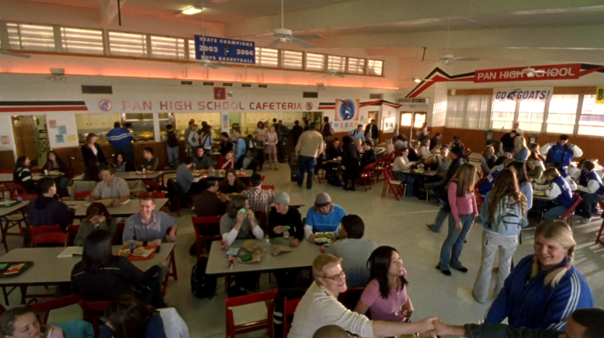 Screenshot from S1E16 of Veronica Mars. A wide shot of Pan High cafeteria filled with students