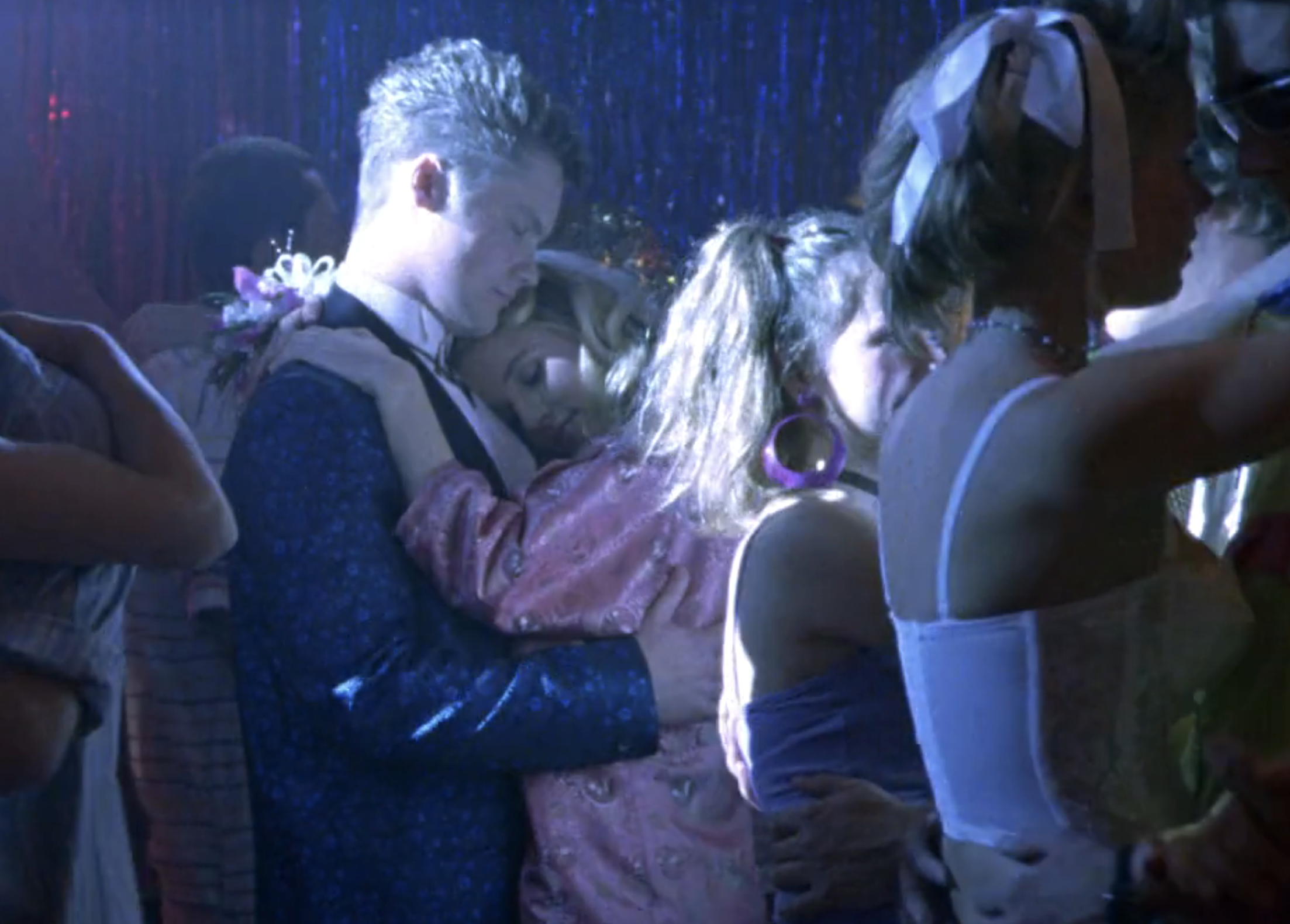 Screenshot from Veronica Mars S1E15. Duncan and Meg are slow dancing. Duncan is resting his head on Meg's head and she's holding him by the shoulders and leaning on his chest.