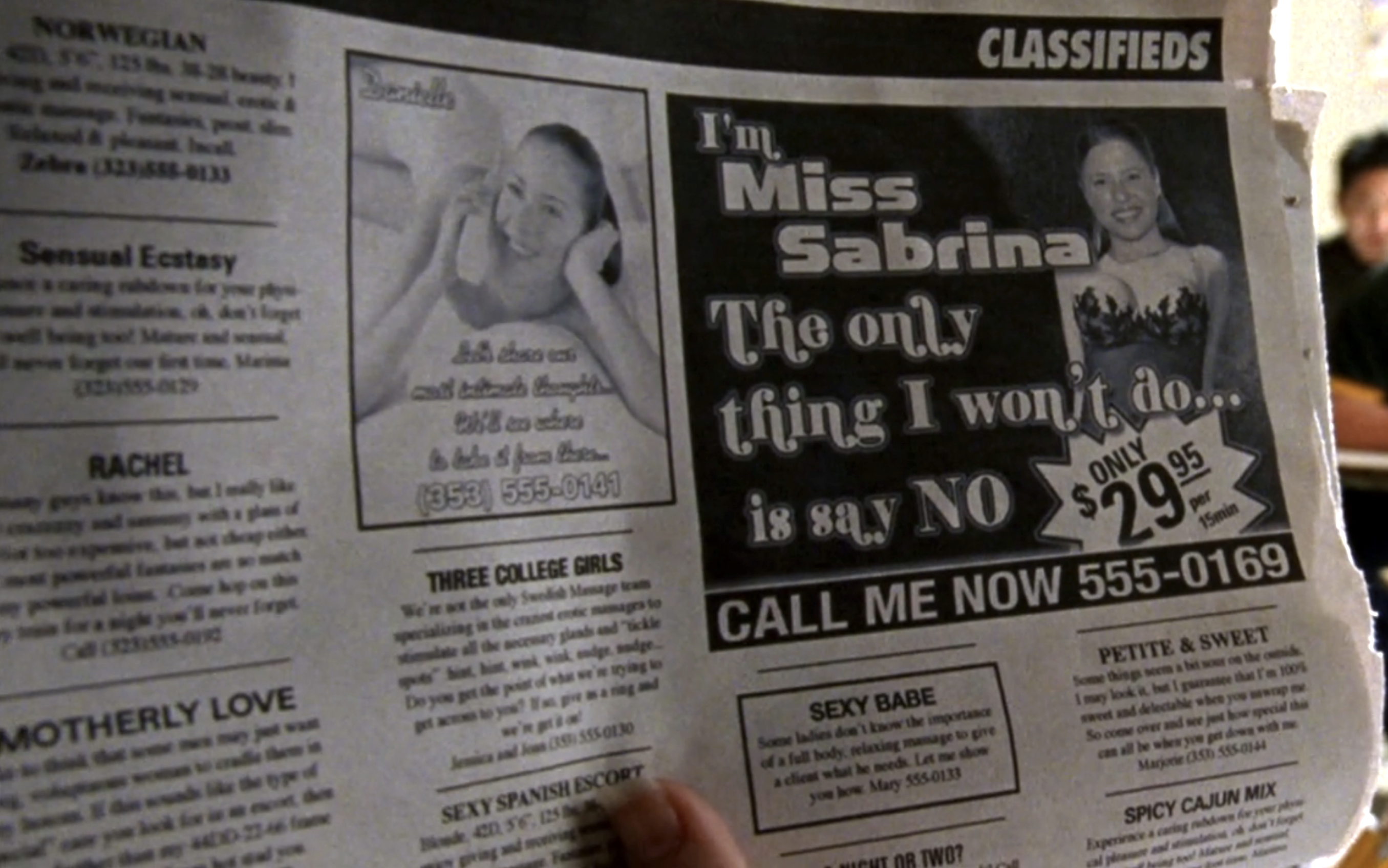 Screenshot from S1E17 of Veronica Mars. A page from the classifieds of a newspaper. The largest ad reads "I'm Miss Sabrina. The only thing I won't do is say no. Only $29.95 per 15 min."