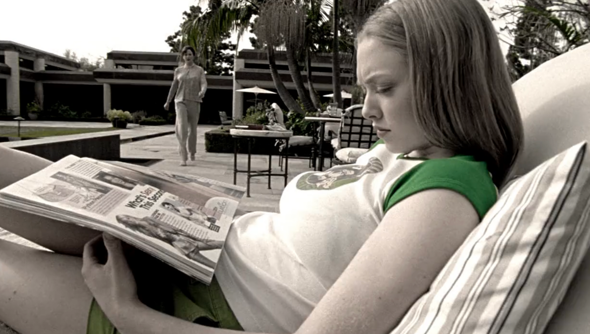 Screenshot from S1E17 of Veronica Mars. Lilly is sitting outside on a lounging chair reading a magazine. Celeste approaches in the background.