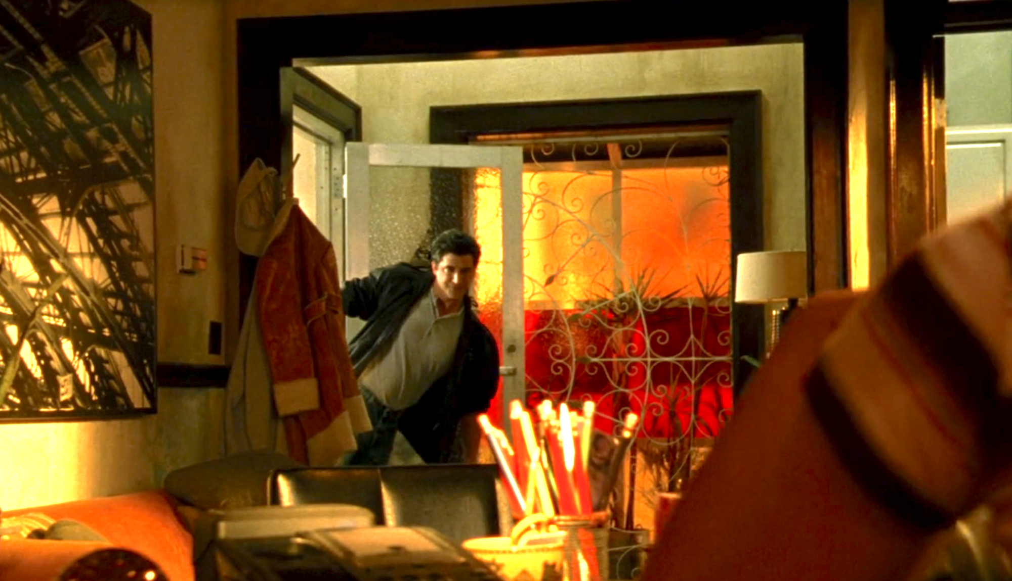 Screenshot from S1E17 of Veronica Mars. Vinnie Van Lowe is seen entering Mars Investigations in a theatrical way